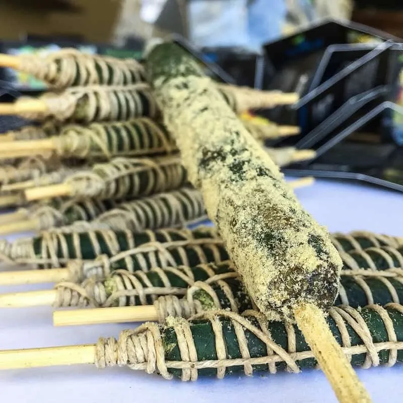 Thai sticks wrapped in sticky fan leaves